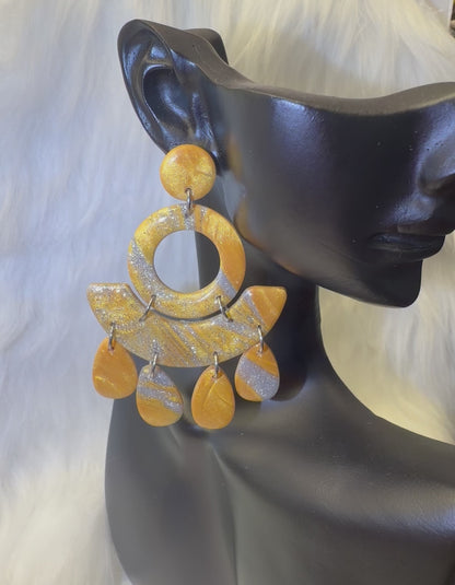 Boucles d'oreilles géométriques en or avec pendentifs.